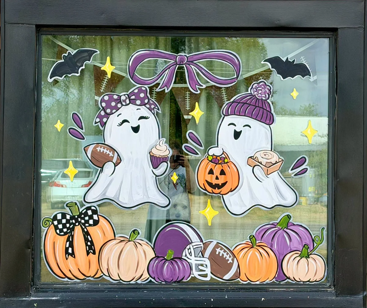 Laurabelle’s window decorated with ghosts, pumpkins, and bows for autumn